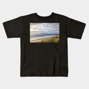 Blustery day on the beach Kids T-Shirt